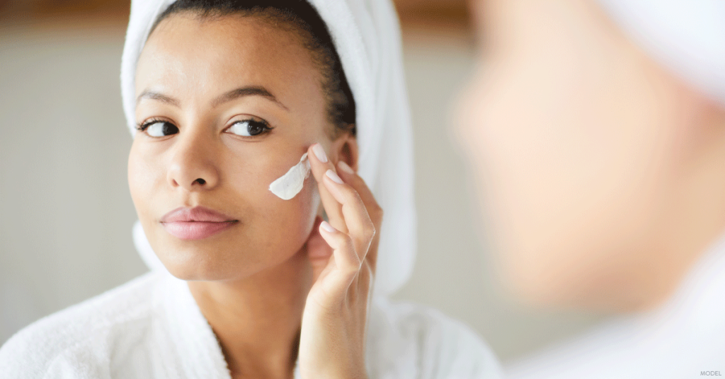 Woman in Dallas, TX applying skincare product recommended by her dermatologist