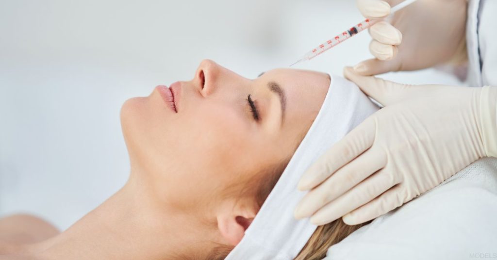 A woman getting a BOTOX injection in her face (MODELS)